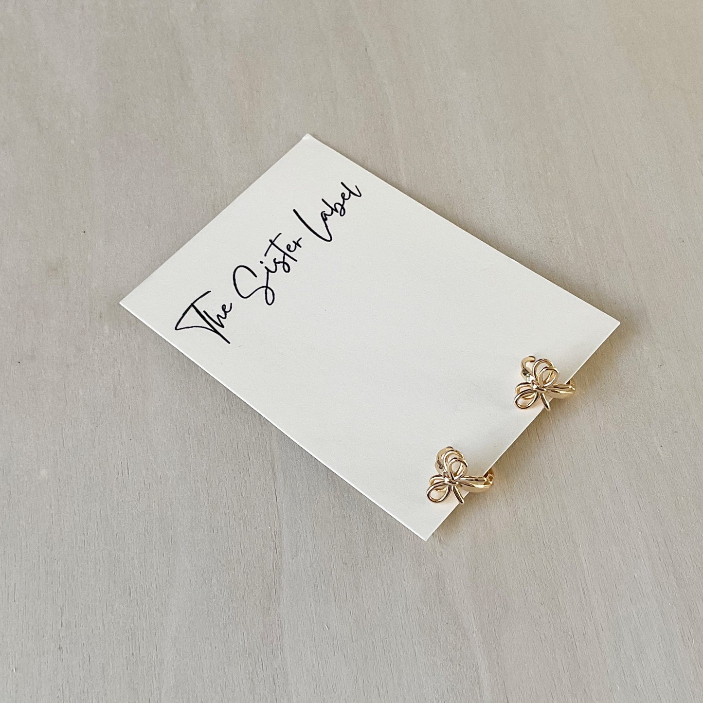 Gold Huggie Hoops - Tied In A Bow